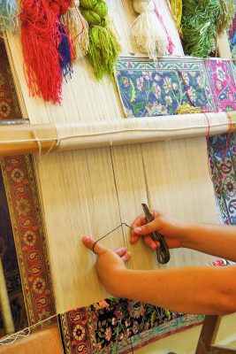 The woman behind work - weaving a carpet of silk